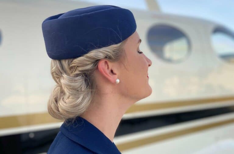 profile of female airline attendant standing next to a plane with eyes closed remembering September 11