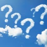 clouds shaped like question marks amid a bright blue sky. Feature image for the article How to Ask Great Questions and Why It’s Life-Giving for All
