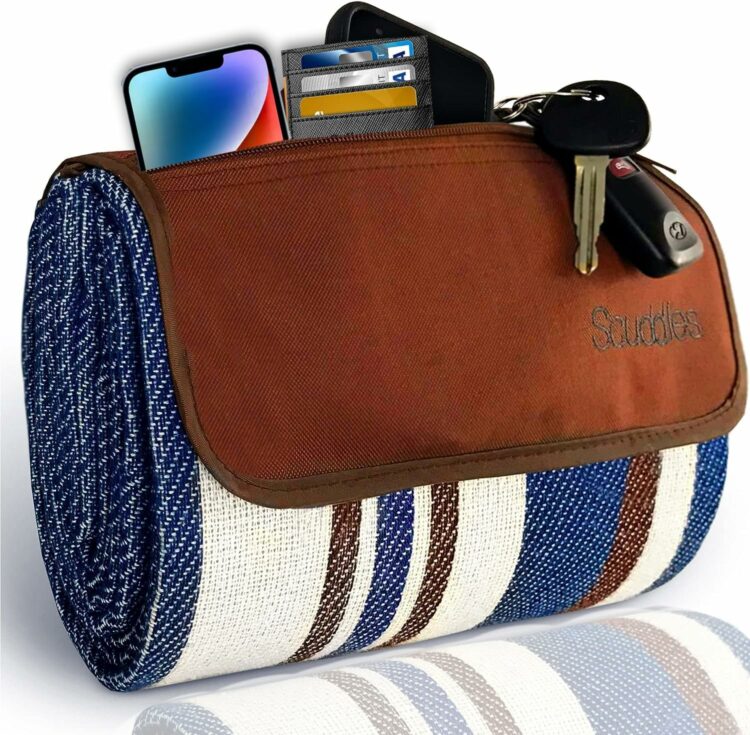 Scuddles blue, brown and white striped blanket with brown leather flap that holds keys, phone and wallet