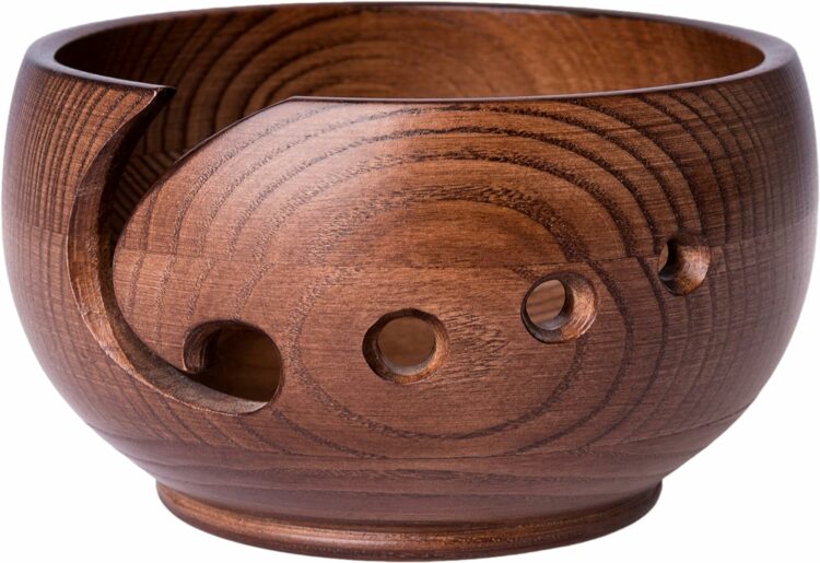 brown yarn bowl with holes in the side 