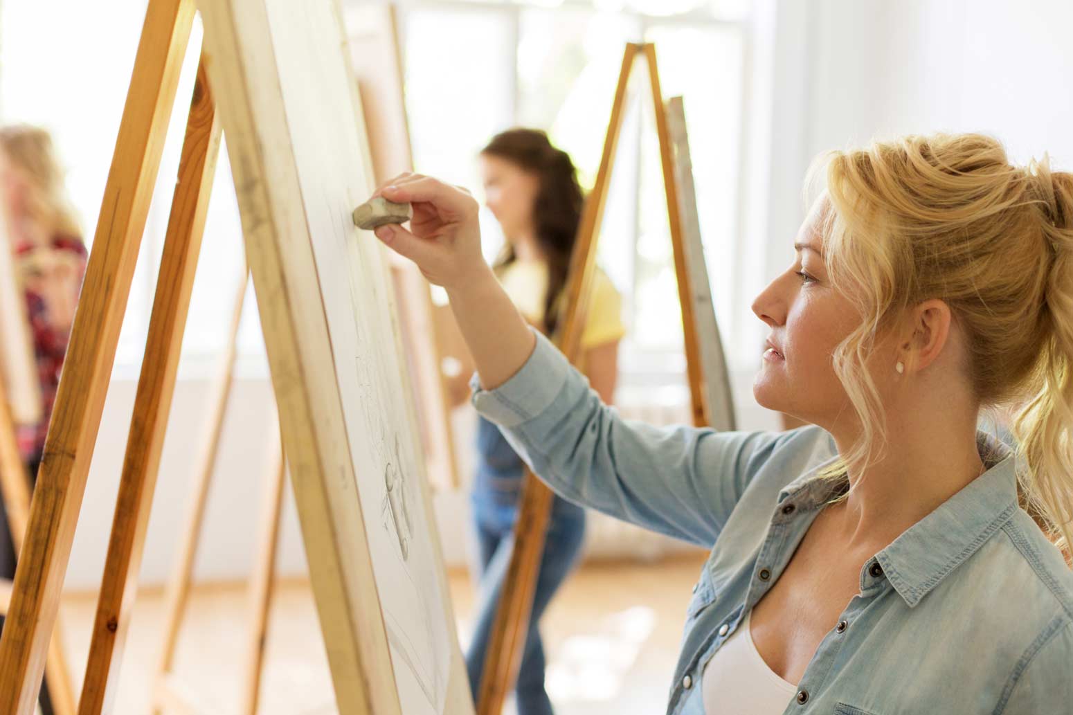 blond woman creating art on a canvas wondering if it's bad to be selfish