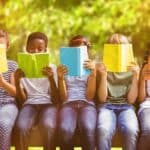 5 kids sitting next to each other outdoors and reading children's Books Celebrating Diversity