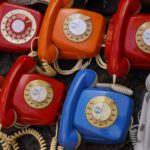 colorful set of rotary dial phones to symbolize calling friends to share retro adages