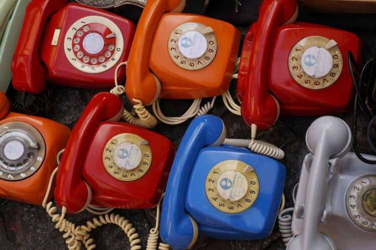 colorful set of rotary dial phones to symbolize calling friends to share retro adages