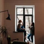 a woman has coffee with another woman in a corner of a home after hearing the other friend is struggling